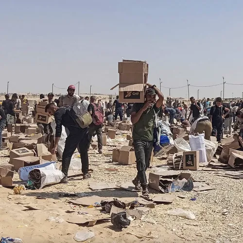 Palestinians gather to collect what remains of relief supplies
